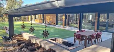 a house with a patio with a table and chairs at Casa Natura Montseny in El Brull