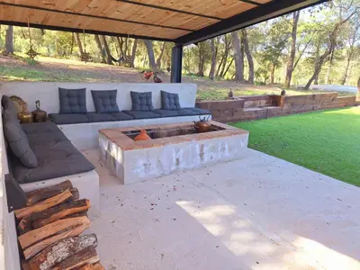 a patio with a couch and a fire pit at Casa Natura Montseny in El Brull