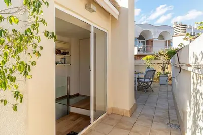 a balcony with glass doors on a house at Canela Homes BARCELONA OLYMPIC in Barcelona