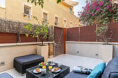 a patio with a couch and a table with food on it at Canela Homes BARCELONA OLYMPIC in Barcelona