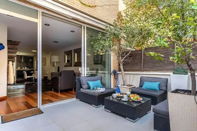 a patio with two chairs and a table at Canela Homes BARCELONA OLYMPIC in Barcelona
