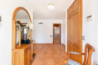 a hallway with a mirror and a wooden dresser at Large 5-Bed Villa, mountain and beach, at 30' from Barcelona & 10' from F1 Circuit in Vallromanas