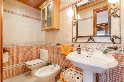 a bathroom with a sink and a toilet at Large 5-Bed Villa, mountain and beach, at 30' from Barcelona & 10' from F1 Circuit in Vallromanas