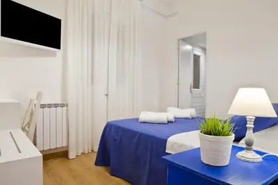 a room with a blue bed with a blue table at Blue Barcelona in Barcelona