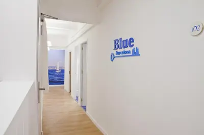 a hallway of a house with a blue sign on the wall at Blue Barcelona in Barcelona