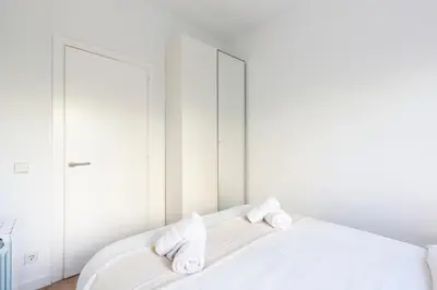 a bathroom with a toilet and a sink and a television at Suites Barcelona Park Güell in Barcelona
