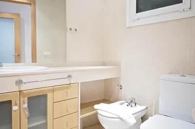 a bedroom with a desk and a bed and a window at Suites Barcelona Park Güell in Barcelona