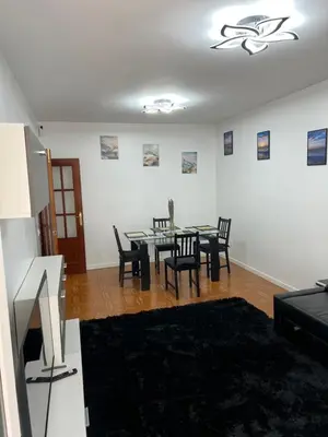 a living room with a dining room table and chairs at Logement avec vue latérale mer in Pineda de Mar