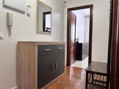 a bathroom with a cabinet and a mirror on the wall at Logement avec vue latérale mer in Pineda de Mar