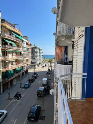 a view of a city street from a balcony of a building at Logement avec vue latérale mer in Pineda de Mar
