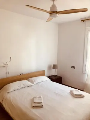 a bedroom with a bed with two towels on it at Sant Guillem in Vilassar de Mar