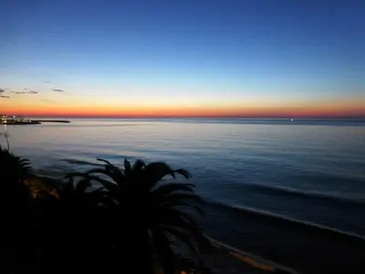 a view of the ocean at sunset at Apartment La Rosa (Blaumar) in Sant Andreu de Llavaneres