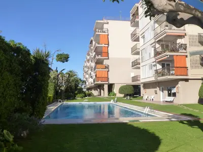 a swimming pool in front of a building at Apartment La Rosa (Blaumar) in Sant Andreu de Llavaneres