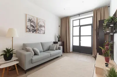 a living room with a couch and a window at Sagrada Familia Apartment in Barcelona