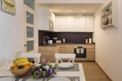 a kitchen with a table with a bowl of fruit on it at Sagrada Familia Apartment in Barcelona