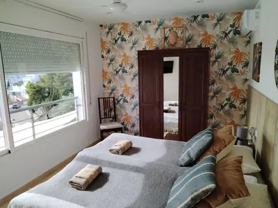 a bedroom with a bed with two towels on it at The Villa Sunlight in Sitges