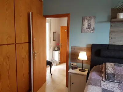 a bedroom with a bed and a table with a lamp at The Villa Sunlight in Sitges