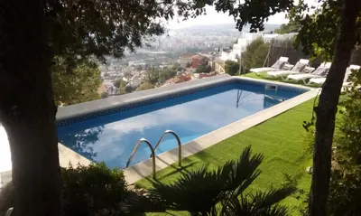 a swimming pool with a view of the city at The Villa Sunlight in Sitges