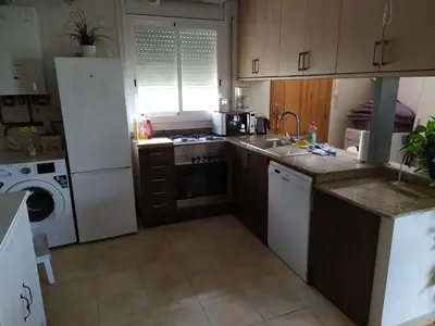 a kitchen with a sink and a stove top oven at The Villa Sunlight in Sitges