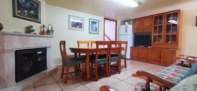 a kitchen with a table and chairs and a fireplace at Joanet Guarda turismo familiar en plena naturaleza in La Guardiola