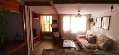 a living room with a couch and a table at Joanet Guarda turismo familiar en plena naturaleza in La Guardiola