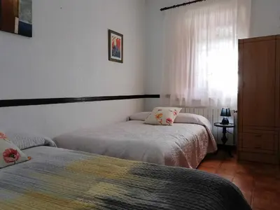 a bedroom with two beds and a window at Joanet Guarda turismo familiar en plena naturaleza in La Guardiola