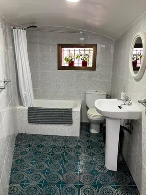 a bathroom with a tub and a toilet and a sink at Loft Rural Barcelona in Barcelona