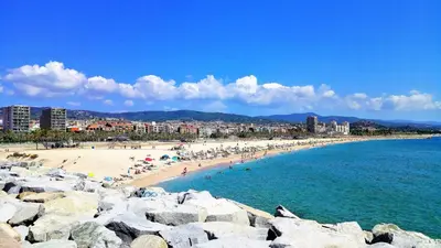a group of people on a beach near the water at Villa Antonia in Mataró