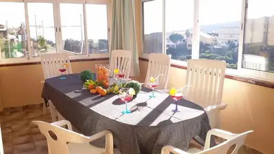 a table with chairs and a table with wine glasses at Villa Antonia in Mataró