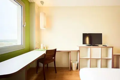 a room with a desk with a tv and a chair at Travelodge BCN Cornella Fira in Cornellà de Llobregat