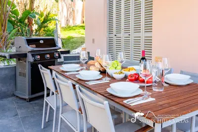 a kitchen with a large wooden table and chairs at Stylish Villa Havana with Sea Views, Private Pool & A/C in Sitges