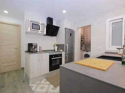 a kitchen with a counter top and a microwave at Cel i Mar Canet in Canet de Mar