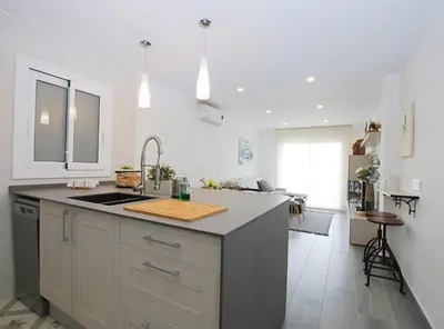 a kitchen with a sink and a counter top at Cel i Mar Canet in Canet de Mar