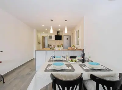a kitchen and dining room with a table and chairs at Cel i Mar Canet in Canet de Mar
