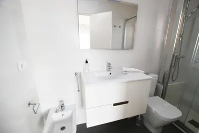 a bathroom with a sink and a toilet and a mirror at Narciso views in Vilassar de Mar
