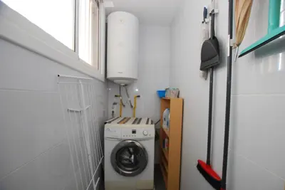 a small laundry room with a washer and dryer at Narciso views in Vilassar de Mar