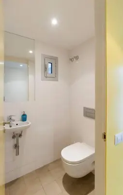a bathroom with a toilet and a sink at Central Verdete in Barcelona
