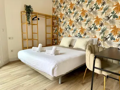 a bedroom with a large bed and a couch at Crysoyle Apartment II Barcelona Next to Camp Nou in Hospitalet de Llobregat