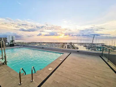 a swimming pool on the roof of a building at Seaside Badalona Apartment in Badalona