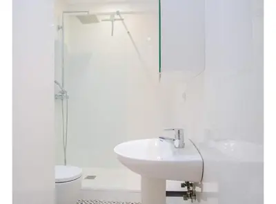 a white bathroom with a sink and a toilet at BALMES - Atico con terraza en Sant Gervasi in Barcelona