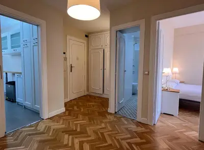 a hallway with two doors and a room with a bed at BALMES - Atico con terraza en Sant Gervasi in Barcelona
