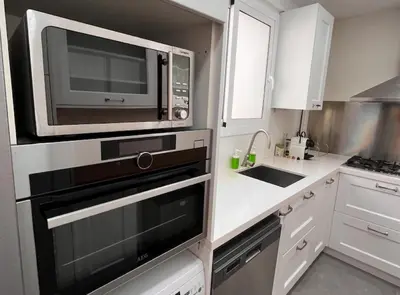 a kitchen with a microwave and a sink at BALMES - Atico con terraza en Sant Gervasi in Barcelona