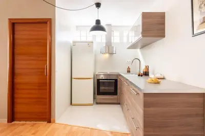 a kitchen with a refrigerator and a sink at Casa Mar Blava con piscina comunitaria junto Barcelona Centro in Alella
