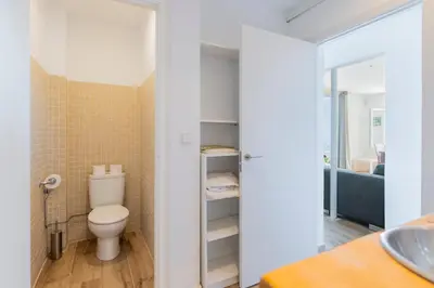 a bathroom with a toilet and a sink at Casa Mediterrani & piscina comunitaria junto Barcelona in Alella