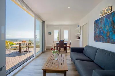 a living room with a couch and a table at Casa Mediterrani & piscina comunitaria junto Barcelona in Alella