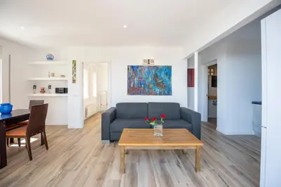 a living room with a couch and a table at Casa Mediterrani & piscina comunitaria junto Barcelona in Alella