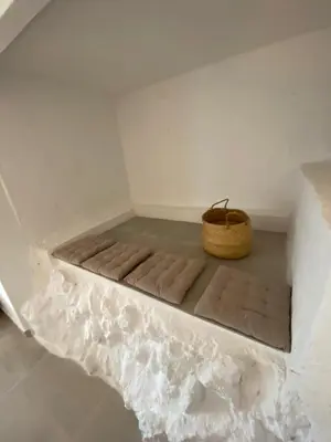 a bed in a room with a basket on the floor at Pandi's Place in Sant Pere de Ribes