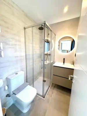 a bathroom with a shower and a toilet and a sink at Pandi's Place in Sant Pere de Ribes