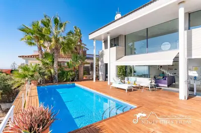 a living room with a couch and a table at Super Villa Oasis Fab Sea and Sitges View with Private Pool and Air Conditioning in Sitges