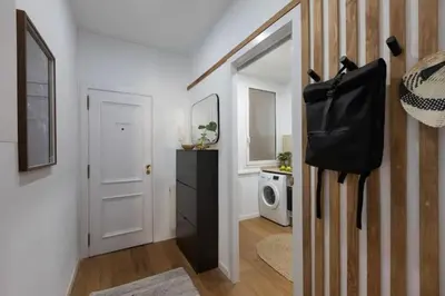 a room with a hallway with a black bag on the wall at Bantu - 1 bedroom and balcony in Eixample Esquerra in Barcelona